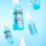 Hyglo self tan serum bottles floating in mid air on blue background